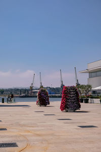 People at commercial dock against clear blue sky