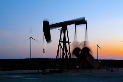 Pump jack in motion on a wind farm in ft. davis, texas