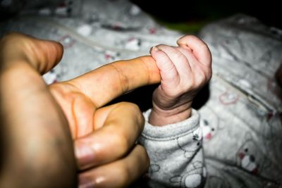 Close-up of baby hand holding baby