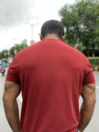 Rear view of man standing against red rock