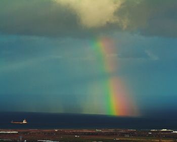 Scenic view of rainbow over trees