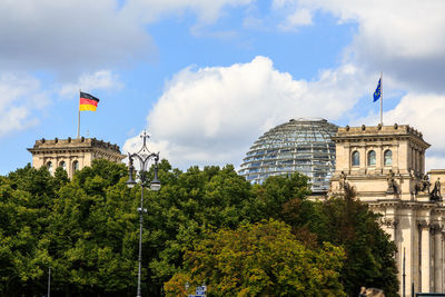Low angle view of reichstag building against cloudy sky