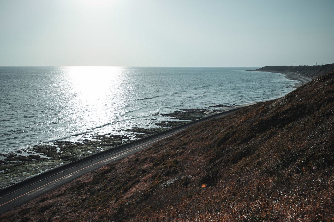 sea, water, horizon, sky, ocean, beach, land, coast, scenics - nature, horizon over water, shore, beauty in nature, wave, body of water, nature, tranquility, tranquil scene, rock, sunlight, morning, no people, sand, bay, environment, terrain, idyllic, seascape, outdoors, clear sky, day, coastline, dusk, reflection, travel destinations, sunrise, non-urban scene, motion, cliff, travel, sun, wind wave, cloud, landscape