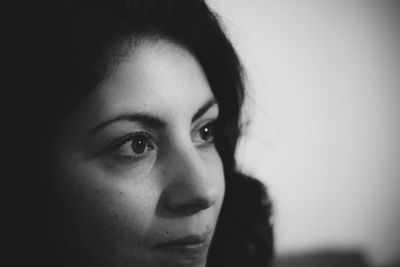 Close-up portrait of beautiful young woman looking away