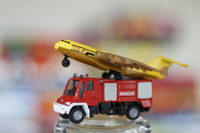 Close-up of airplane model on fire engine toy