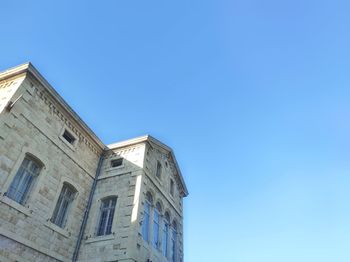 Low angle view of a xix century building against blue sky