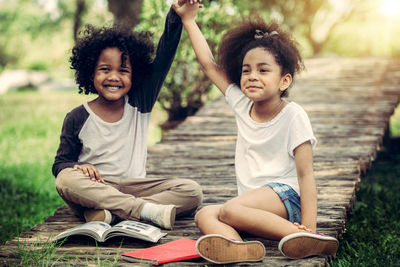 Portrait of smiling girl sitting outdoors