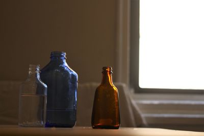 Close-up of bottles on table at home