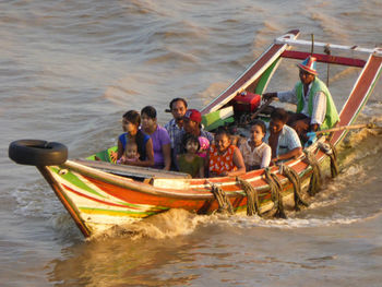 People in boat at sea shore