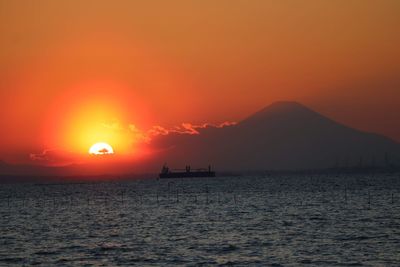 Scenic view of sea against orange sky