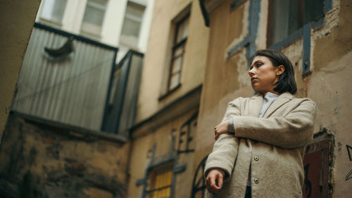 Portrait of young woman in city