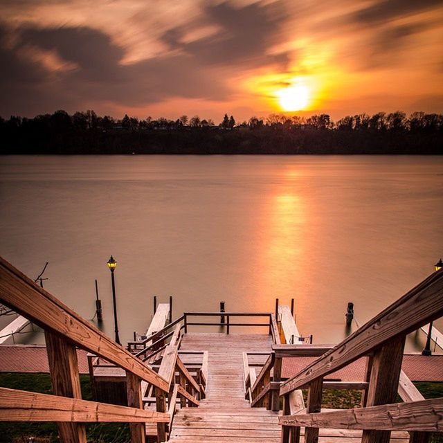 sunset, sky, pier, water, wood - material, orange color, railing, tranquility, scenics, tranquil scene, beauty in nature, lake, cloud - sky, boardwalk, nature, built structure, idyllic, sun, jetty, wood