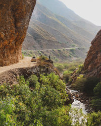 Scenic view of river amidst mountains