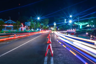 Light trails on road in city at night