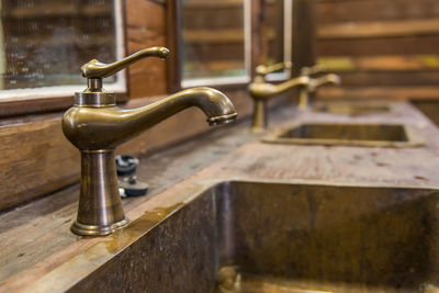 Close-up of faucet on table