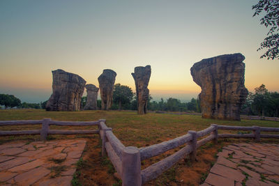 Stone structure against sky during sunset