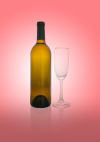 Close-up of beer glass bottle against red background