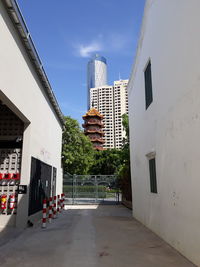 Street amidst buildings against sky