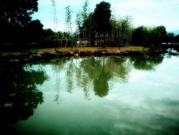 Reflection of trees in lake against sky