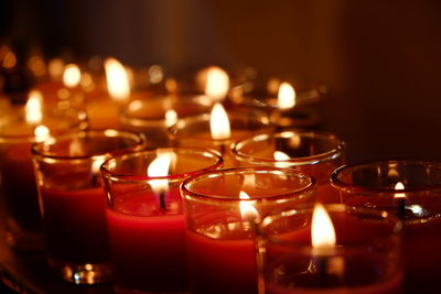 Close-up of lit tea light candles in temple