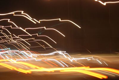 Light trails against sky at night