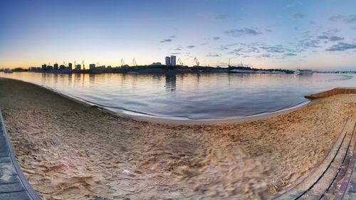 Scenic view of beach against sky during sunset