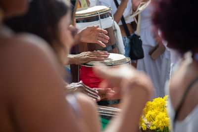 Musicians play percussion during a party for iemanja 