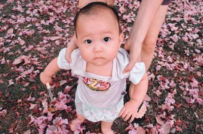 Portrait of cute baby girl with leaves