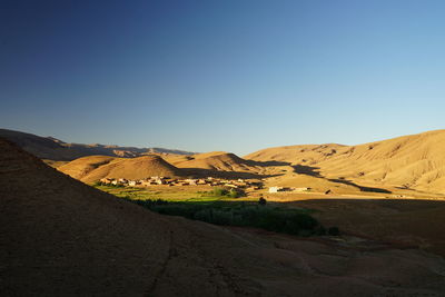 Scenic view of moroccan mountain village against clear blue sky sunset 