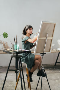 Young woman sitting on table