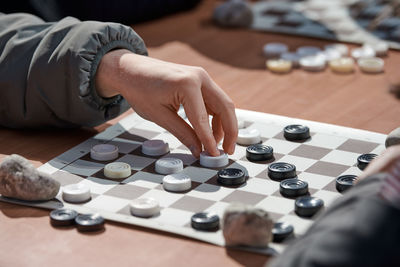 Midsection of man playing chess