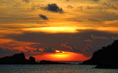 Scenic view of sea against romantic sky at sunset