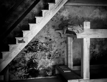 Low angle view of cross on staircase against building