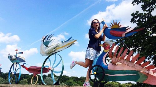 Woman standing on field against clear sky