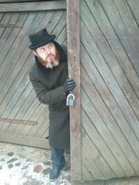 Portrait of man standing on wood