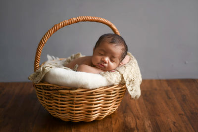 High angle view of cute baby boy in basket