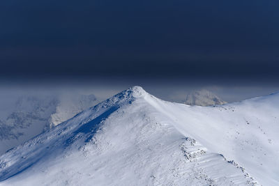 Scenic view of snowcapped mountain against sky