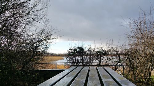 View of fence against cloudy sky