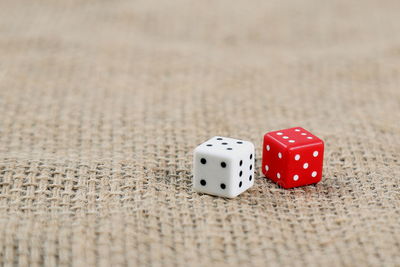 High angle close-up of dices on jute