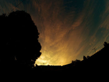 Low angle view of silhouette built structure against sky at dusk
