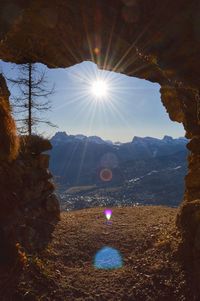 Scenic view of mountains against bright sun