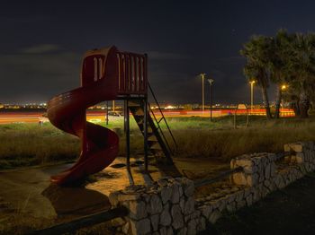View of playground against sky at night
