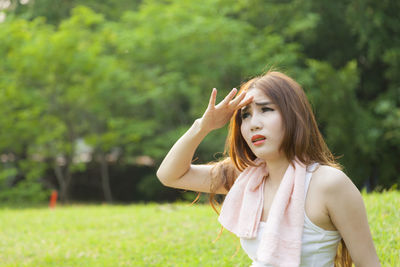 Woman sitting on field at park