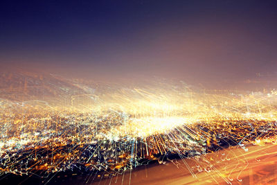 Aerial view of illuminated cityscape at night