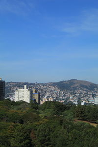 Buildings in city against blue sky