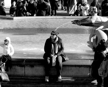 Full length of woman standing on bench