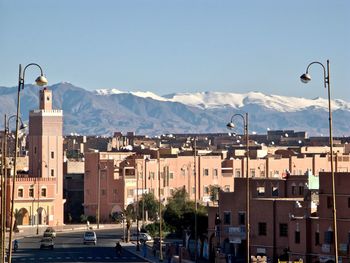 Morocco, ouarzazat - city center and snowcapped atlas mountains in the background