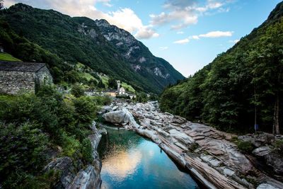 Scenic view of river amidst mountains against sky