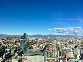 High angle view of buildings against blue sky