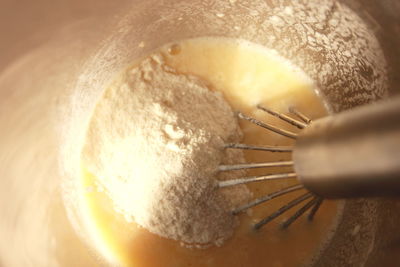 Close-up wire whisk in flour